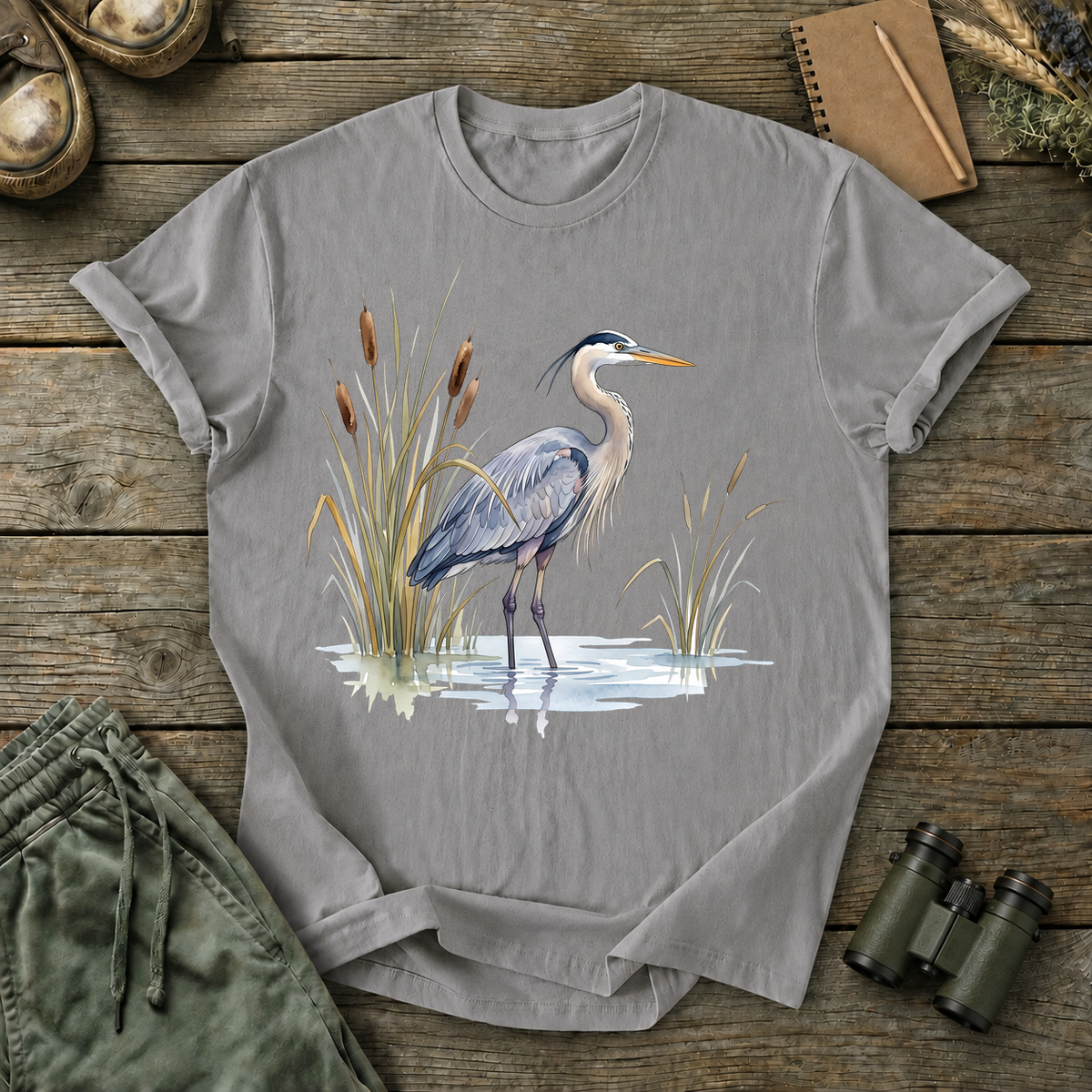 Great Blue Heron Wetland Watercolor Tee in Grey, centered front design on a birdwatching flat-lay mockup