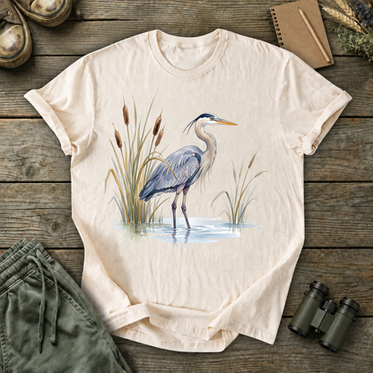 Great Blue Heron Wetland Watercolor Tee in Ivory, centered front design on a birdwatching flat-lay mockup