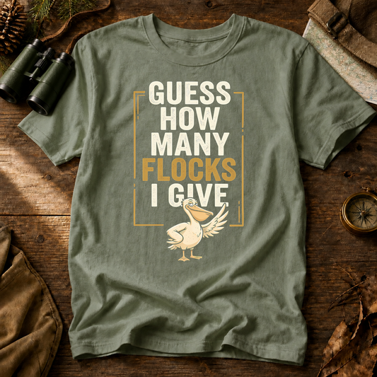 Guess How Many Flocks I Give Tee in Bay, centered front design on a birdwatching flat-lay mockup
