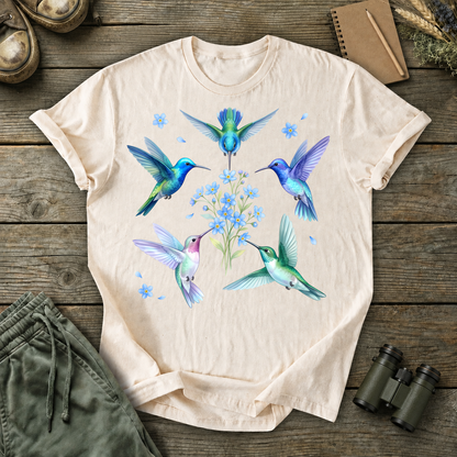 Hummingbird Floral Circle Tee in Ivory, centered front design on a birdwatching flat-lay mockup