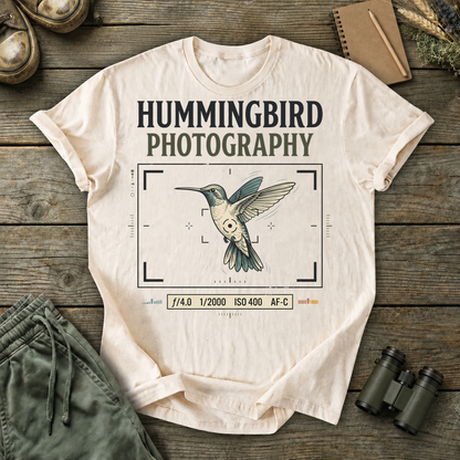 Hummingbird Photography Camera Settings Tee in Ivory, centered front design on a birdwatching flat-lay mockup