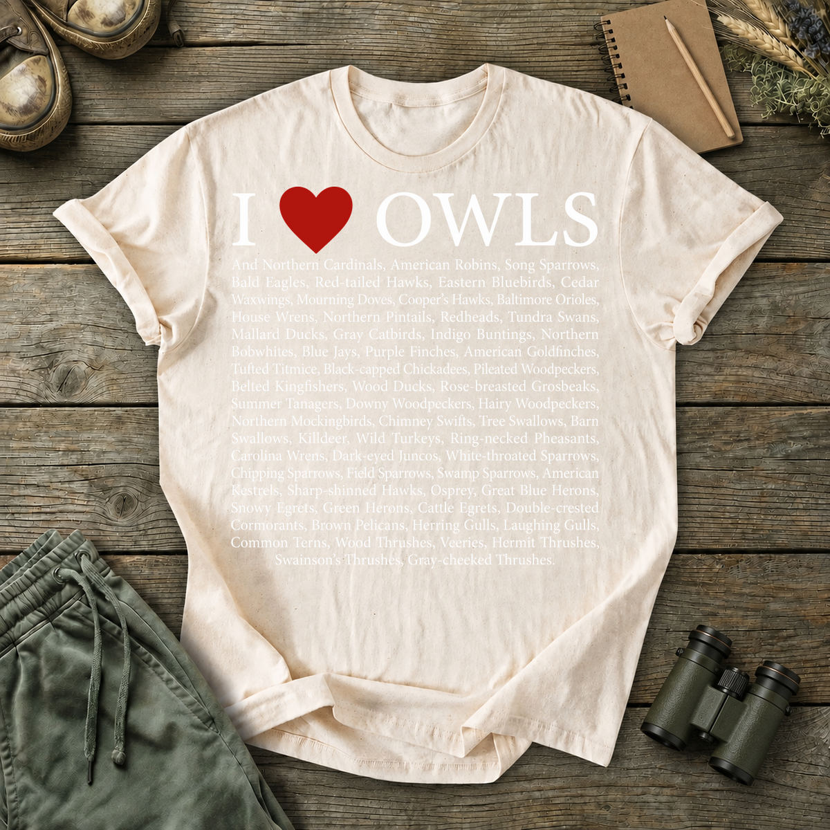 I Love Owls Bird List Tee in Ivory, centered front design on a birdwatching flat-lay mockup