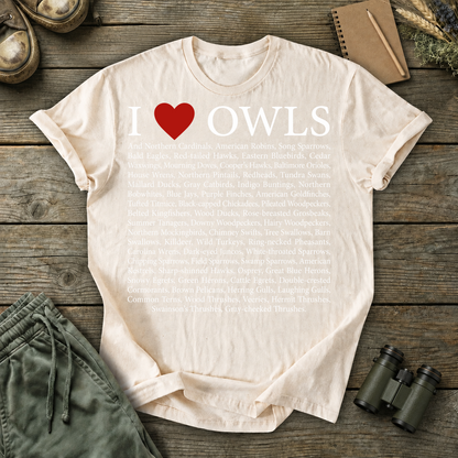 I Love Owls Bird List Tee in Ivory, centered front design on a birdwatching flat-lay mockup