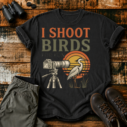I Shoot Birds for Fun Photography Tee in Black, centered front design on a birdwatching flat-lay mockup