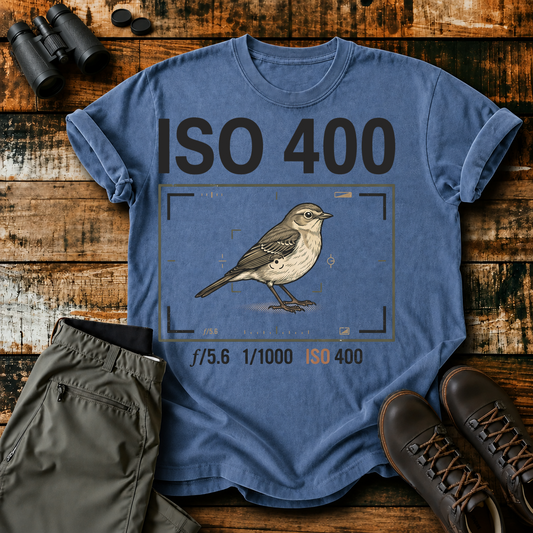 ISO 400 Bird Photography Tee in Blue Jean, centered front design on a birdwatching flat-lay mockup