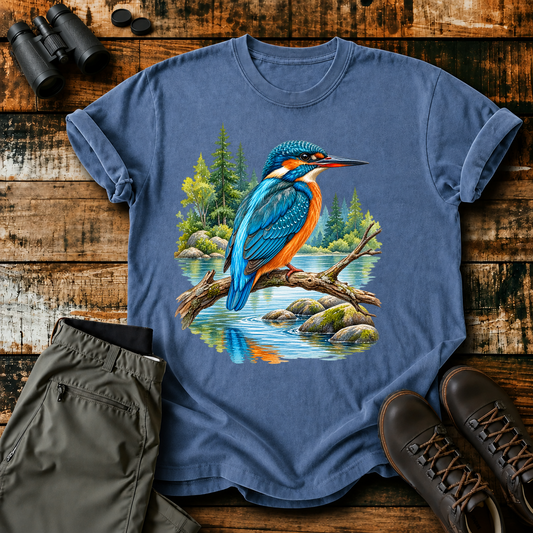 Kingfisher Woodland Stream Tee in Blue Jean, centered front design on a birdwatching flat-lay mockup