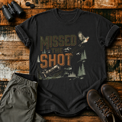 Missed the Shot Bird Photography Tee in Black, centered front design on a birdwatching flat-lay mockup