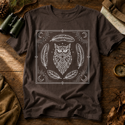 Mystical Owl and Feathers Line Art Tee in Espresso, centered front design on a birdwatching flat-lay mockup