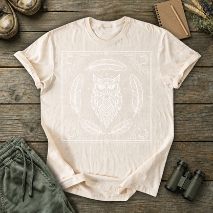 Mystical Owl and Feathers Line Art Tee in Ivory, centered front design on a birdwatching flat-lay mockup