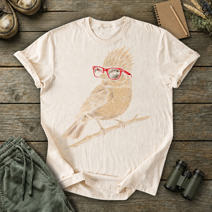 Nerdy Owl Red Glasses Tee in Ivory, centered front design on a birdwatching flat-lay mockup