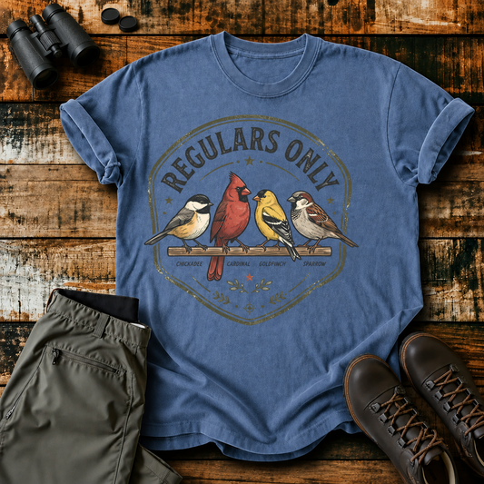 Regulars Only Backyard Birds Tee in Blue Jean, centered front design on a birdwatching flat-lay mockup