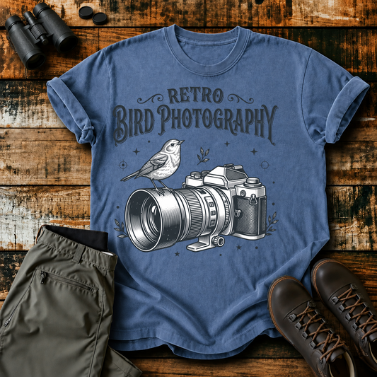 Retro Bird Photography Camera Tee in Blue Jean, centered front design on a birdwatching flat-lay mockup