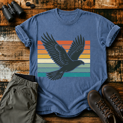 Retro Flying Bird Stripes Tee in Blue Jean, centered front design on a birdwatching flat-lay mockup