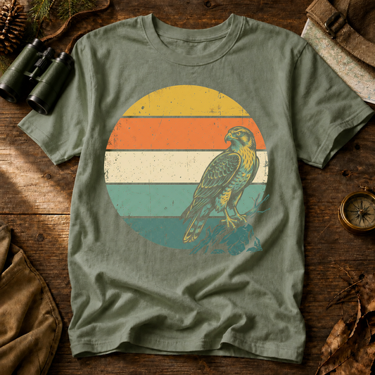 Retro Sunset Raptor Tee in Bay, centered front design on a birdwatching flat-lay mockup