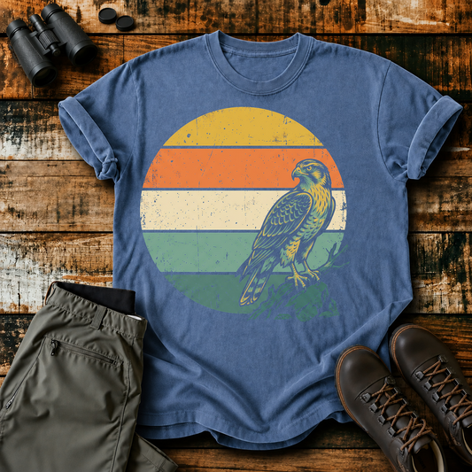 Retro Sunset Raptor Tee in Blue Jean, centered front design on a birdwatching flat-lay mockup