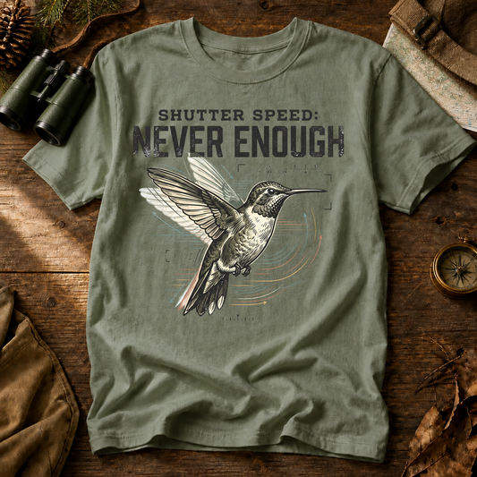 Shutter Speed Never Enough Hummingbird Tee in Bay, centered front design on a birdwatching flat-lay mockup