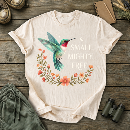 Small Mighty Free Hummingbird Tee in Ivory, centered front design on a birdwatching flat-lay mockup