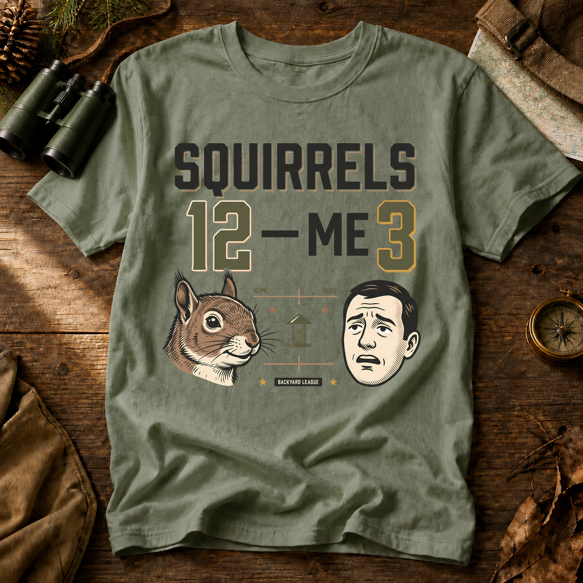 Squirrels 12 Me 3 Backyard Tee in Bay, centered front design on a birdwatching flat-lay mockup
