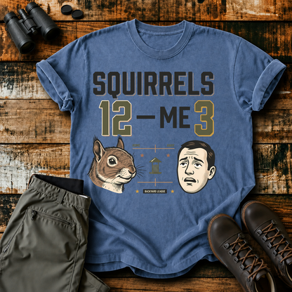 Squirrels 12 Me 3 Backyard Tee in Blue Jean, centered front design on a birdwatching flat-lay mockup
