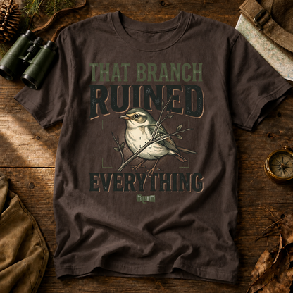 That Branch Ruined Everything Bird Photography Tee in Espresso, centered front design on a birdwatching flat-lay mockup