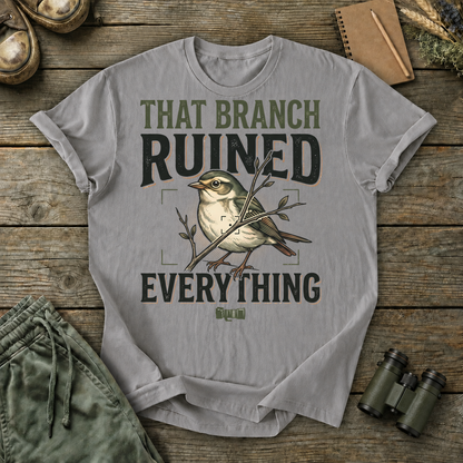 That Branch Ruined Everything Bird Photography Tee in Grey, centered front design on a birdwatching flat-lay mockup
