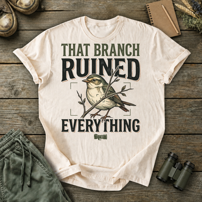 That Branch Ruined Everything Bird Photography Tee in Ivory, centered front design on a birdwatching flat-lay mockup