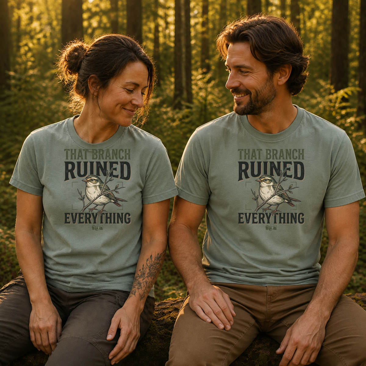 Female and male models wearing the That Branch Ruined Everything Bird Photography Tee in Bay, with the artwork centered on both shirts