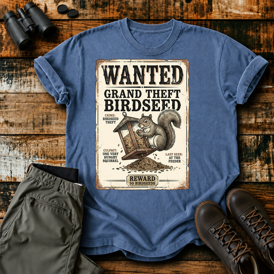 Wanted Grand Theft Birdseed Squirrel Tee in Blue Jean, centered front design on a birdwatching flat-lay mockup