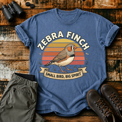Zebra Finch Small Bird Big Spirit Tee in Blue Jean, centered front design on a birdwatching flat-lay mockup